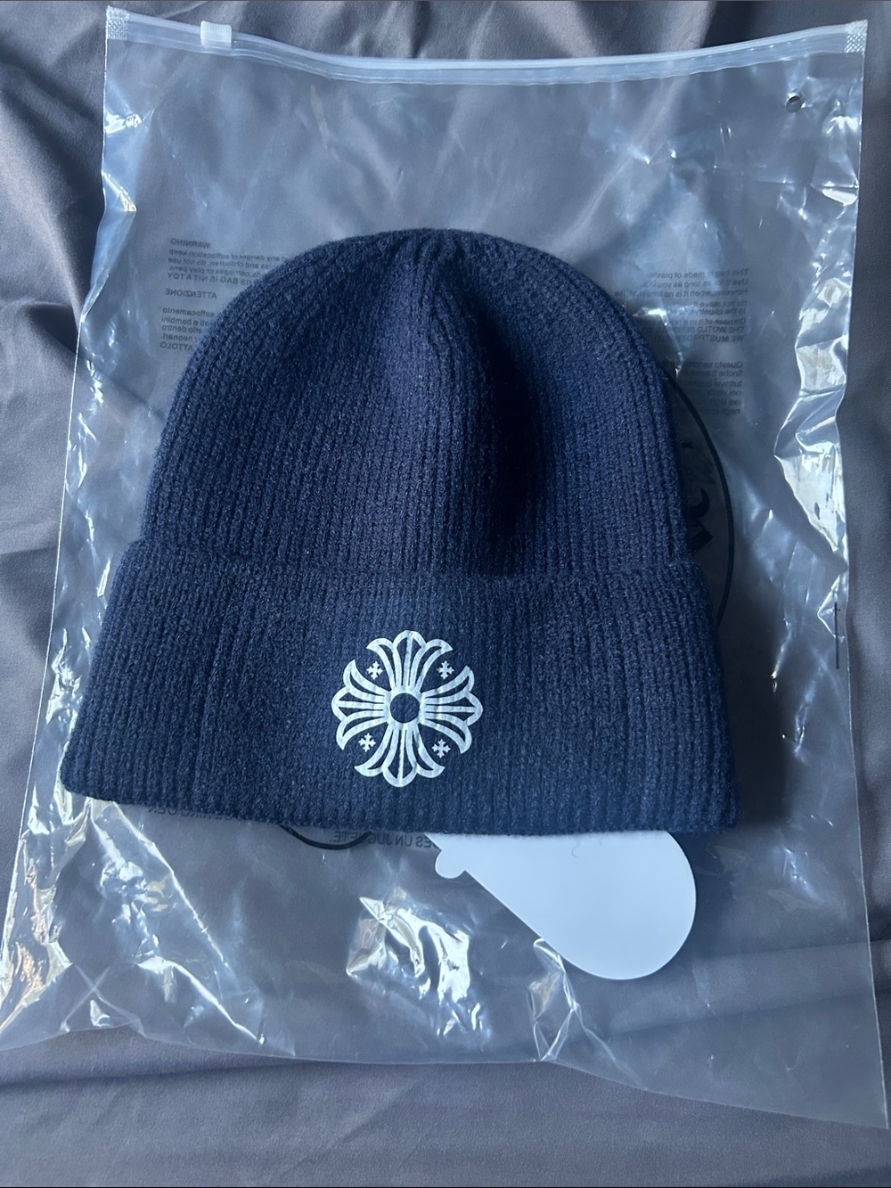 Navy Ribbed Beanie with White Floral Cross Emblem